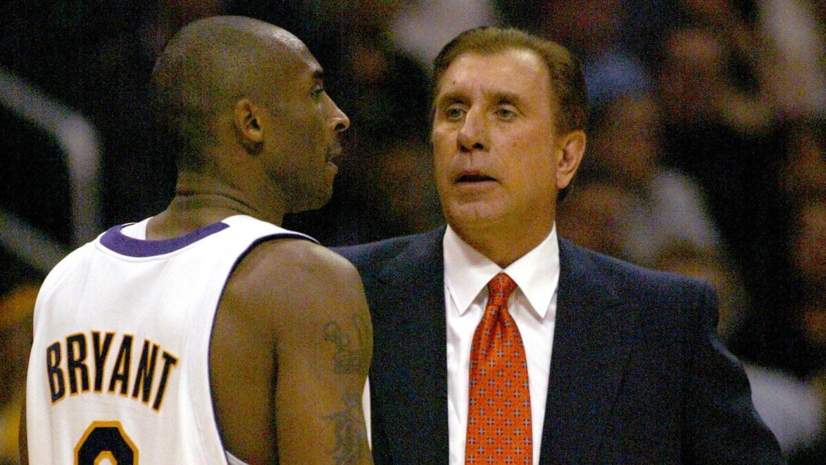 Lakers star Kobe Bryant talks to coach Rudy Tomjanovich.