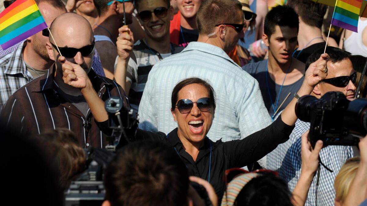 Eleni Tsakopoulos Kounalakis, then the U.S. ambassador to Hungary, waves rainbow flags at a gay pride march in Budapest in 2012. She's now running for lieutenant governor in California.