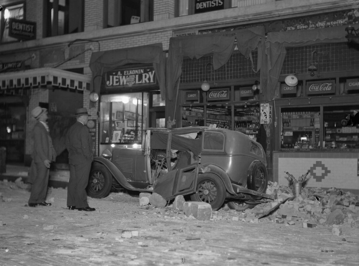 A damaged building and an automobile in San Pedro after a 1933 earthquake.