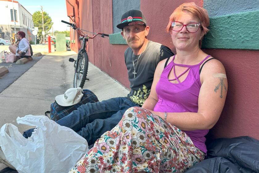 Melissa Crespo received a shot of an antipsychotic medication from a street medicine nurse on a hot June afternoon in Redding, California. She and her boyfriend, Andy Gothan, are homeless and trying to get off meth and into permanent housing. (Angela Hart/KFF Health News)