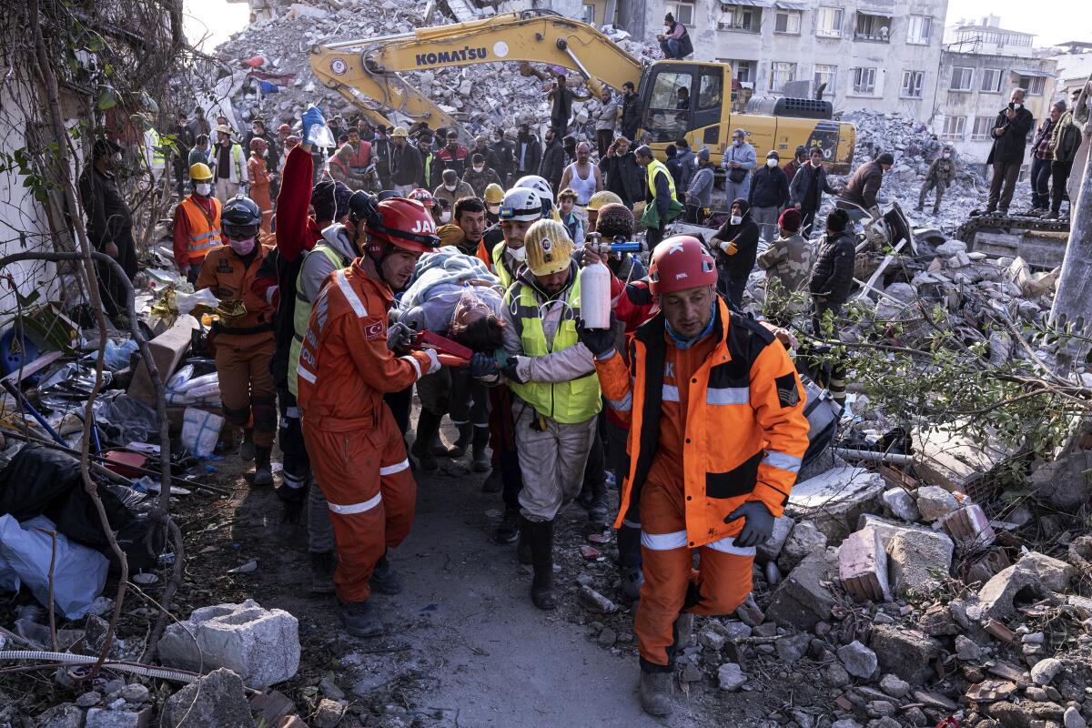 Rescue workers and medics pull out a person from a collapsed building in Antakya, Turkey, on Feb. 15. 