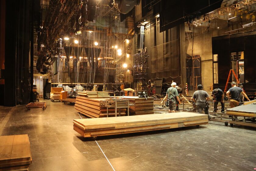 LA Opera’s stage crew members at work building the new set for “Il Trovatore” opening on September 18. 