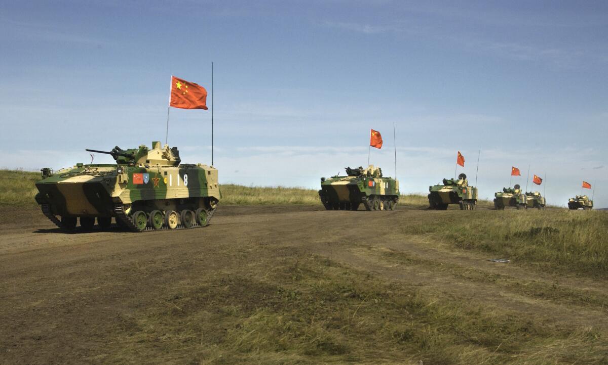 A convoy of Chinese APCs roll by during a 2007 rehearsal for a massive joint military exercise.