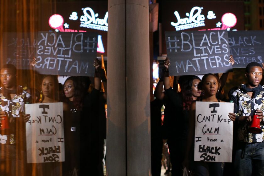 Protesters march Saturday in Atlanta in response to police shooting deaths in Tulsa, Okla., and Charlotte, N.C.