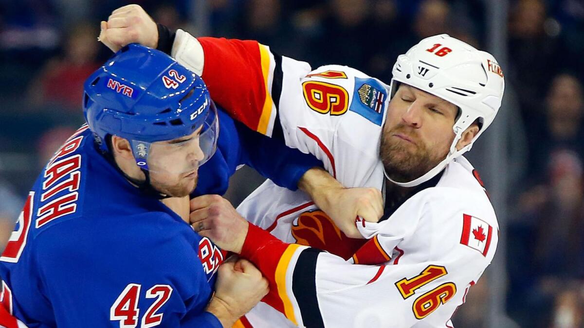 Calgary Flames forward Brian McGrattan, right, fights New York Rangers defenseman Dylan McIlrath during a game on Dec. 15, 2013.