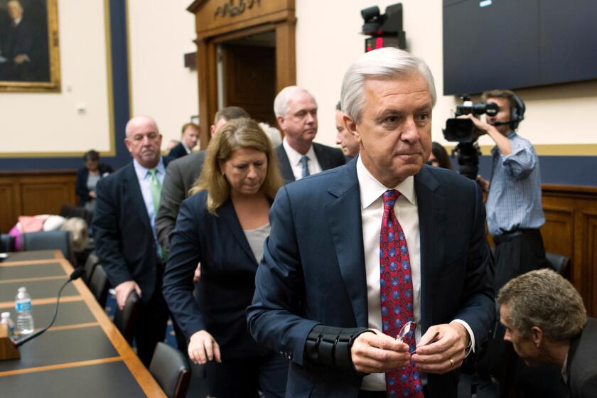 Going, going, gone: Then-Wells Fargo Chairman and CEO John Stumpf leaves a congressional hearing room after a flaying last month.
