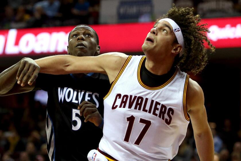Cavaliers center Anderson Varejao, battling for rebounding position against Timberwolves center Gorgui Dieng, is out for the rest of this season after tearing his left Achilles' tendon in the game against Minnesota on Tuesday.