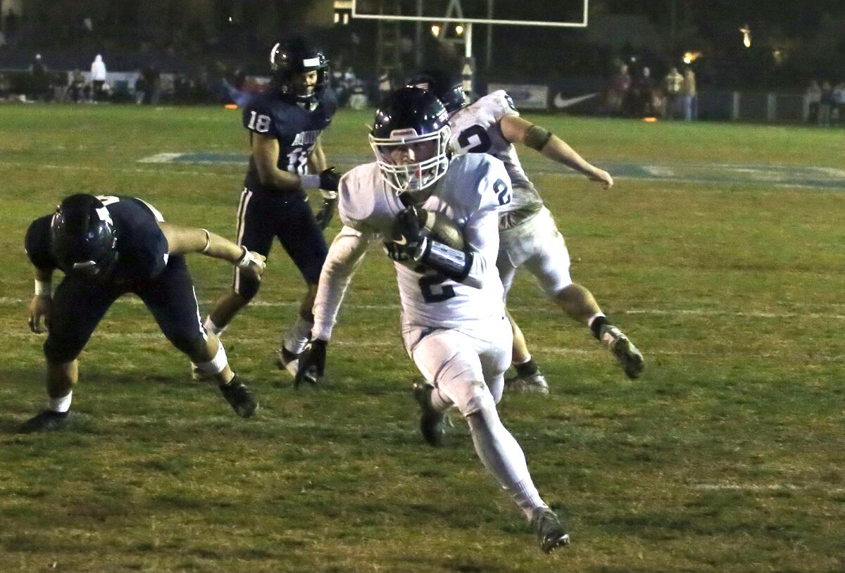 Newport Harbor High's Hayden Farley runs in for a fourth-quarter touchdown during Friday's game at Aquinas High.
