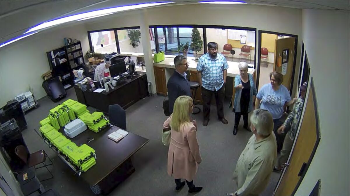 People stand in a circle in an office.
