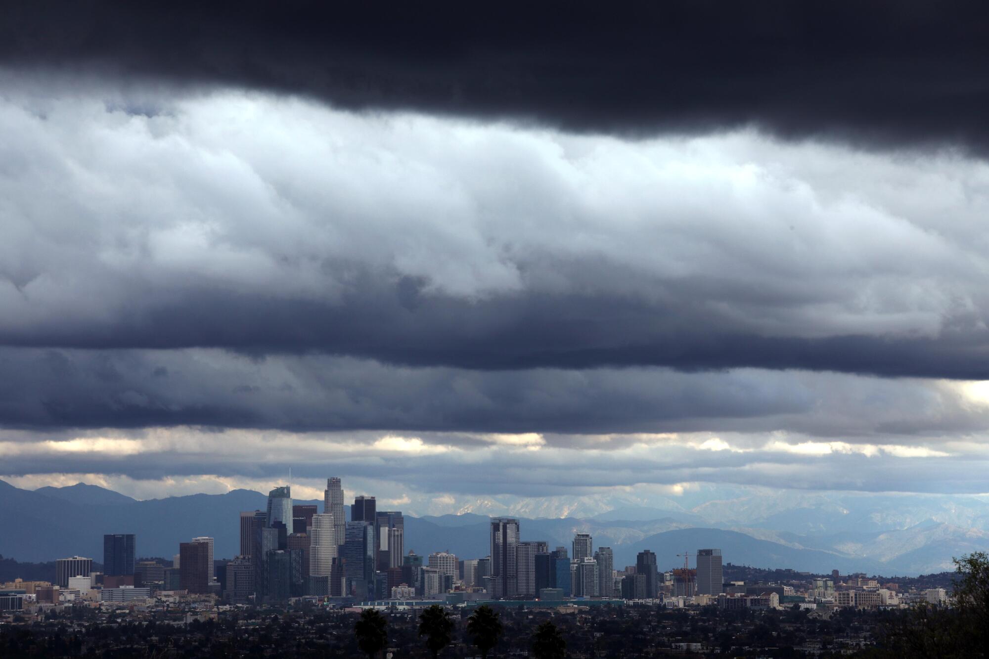 Giant storm clouds hover over the downtown Los Angeles skyline.