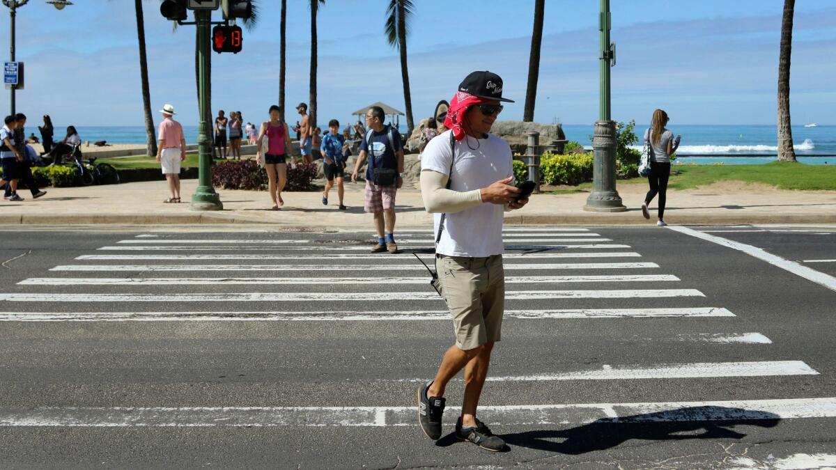 The Hawaiian island of Oahu has adopted an ordinance that outlaws distracted walking, i.e., looking at your smartphone or other device while crossing the street.