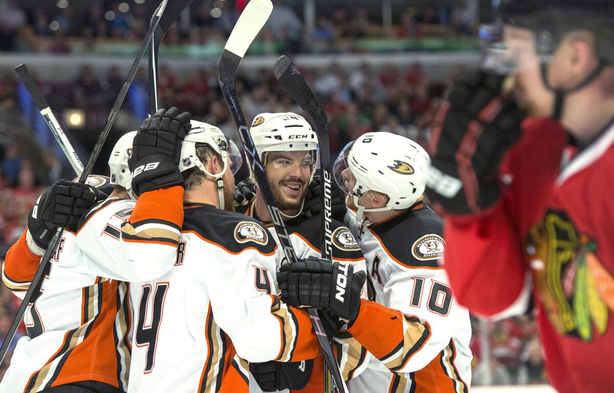 Ducks defenseman Simon Despres is surrounded by his teammates after scoring the go-ahead goal against the Blackhawks in Game 3 of the Western Conference finals.