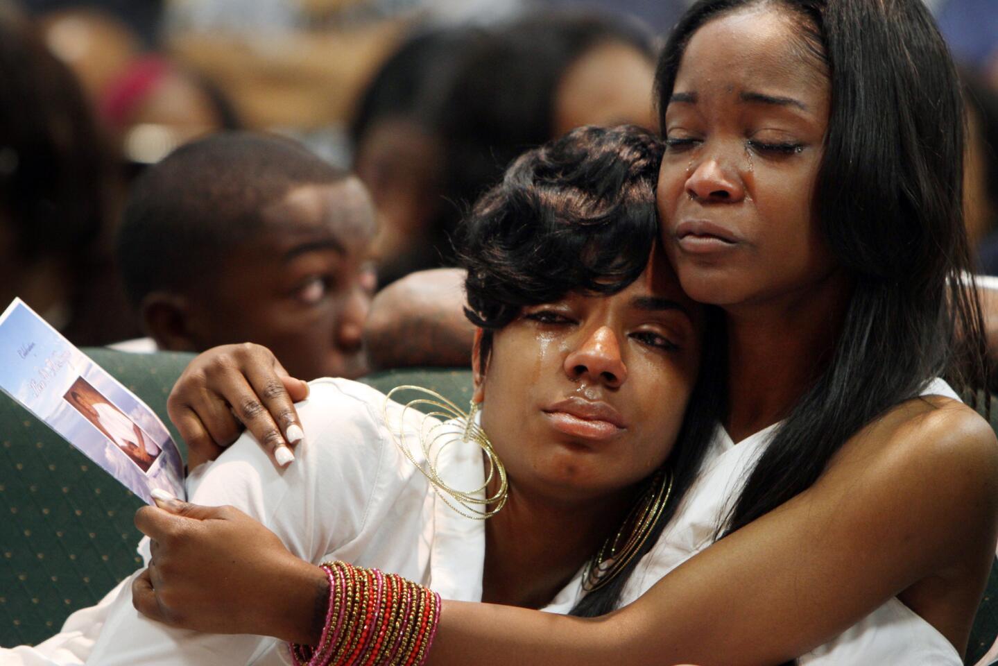 Ken McRoyal's sister Kenesha, left, is consoled by his girlfriend, Latrese Williams, during his memorial service at Mission Ebenezer Family Church in Carson. McRoyal was fatally shot on Mother's Day.