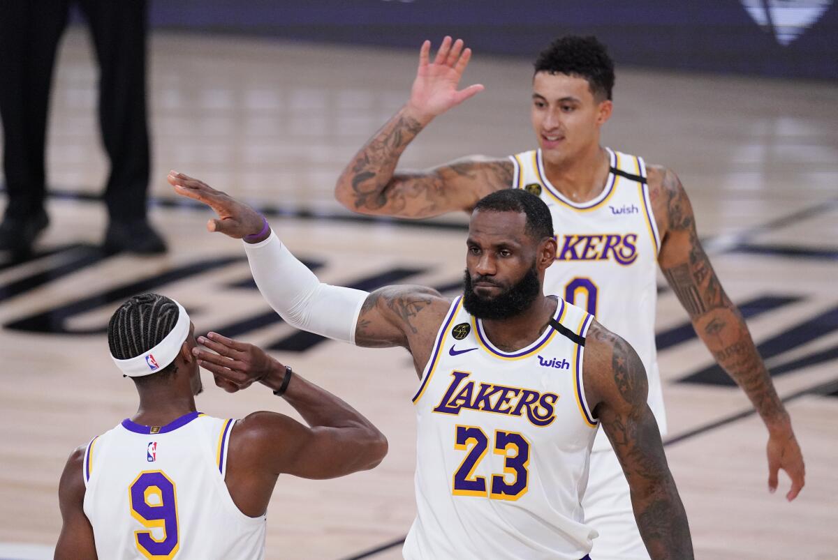 Lakers' LeBron James, Kyle Kuzma and Rajon Rondo celebrate.