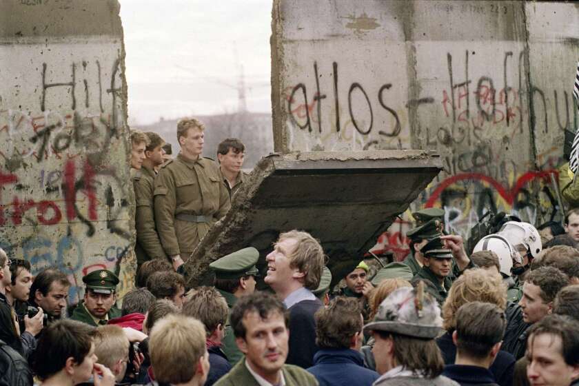 (FILES) - Picture taken on November 11, 1989 shows West Berliners crowd in front of the Berlin Wall as they watch East German border guards demolishing a section of the wall in order to open a new crossing point between East and West Berlin, near the Potsdamer Platz. Germany on November 7, 2014 kicks off a weekend of celebrations marking the 25th anniversary of the epochal fall of the Berlin Wall with millions expected to descend on the reunited capital. AFP PHOTO / GERARD MALIEGERARD MALIE/AFP/Getty Images ** OUTS - ELSENT, FPG - OUTS * NM, PH, VA if sourced by CT, LA or MoD **