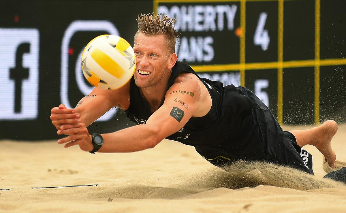 Casey Patterson dives for the ball during a volleyball match at the Hermosa Beach Open in July.