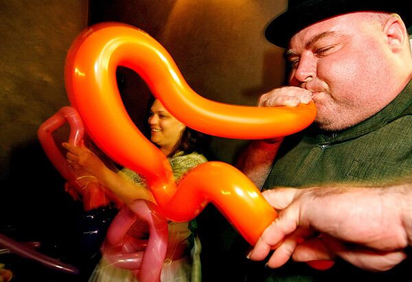 Don Caldwell, a.k.a. Buster Balloon, and his wife, Laura Caldwell, a.k.a. Annie Banannie, work on a witch's hat during a regular gathering of balloon artists at L.A.'s Griddle Cafe. See full story