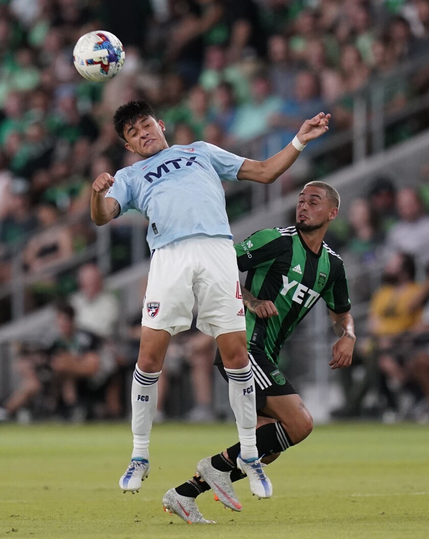 FC Dallas defender Marco Farfan, left, heads the ball past Austin FC defender Ruben Gabrielsen, right, during the second half of an MLS soccer match, Saturday, June 25, 2022, in Austin, Texas. (AP Photo/Eric Gay)