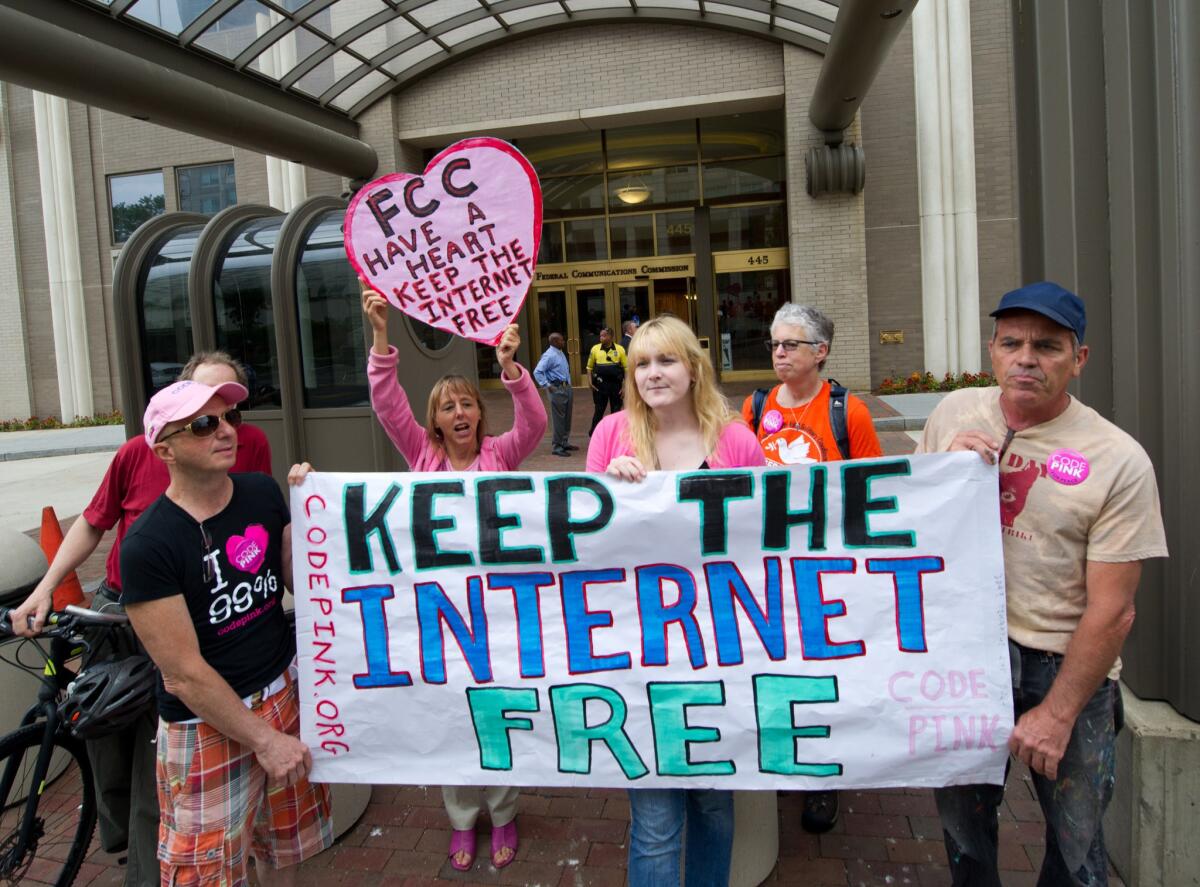 In this May 15, 2014, file photo, protesters hold a rally to support net neutrality outside the Federal Communications Commission headquarters in Washington, D.C.
