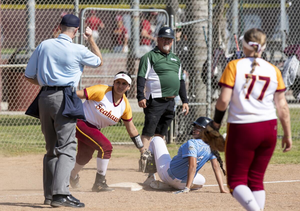 Ocean View's Kaylah Arteaga makes the tag and gets the out against Irvine's Priscilla Sanchez at third on Thursday.