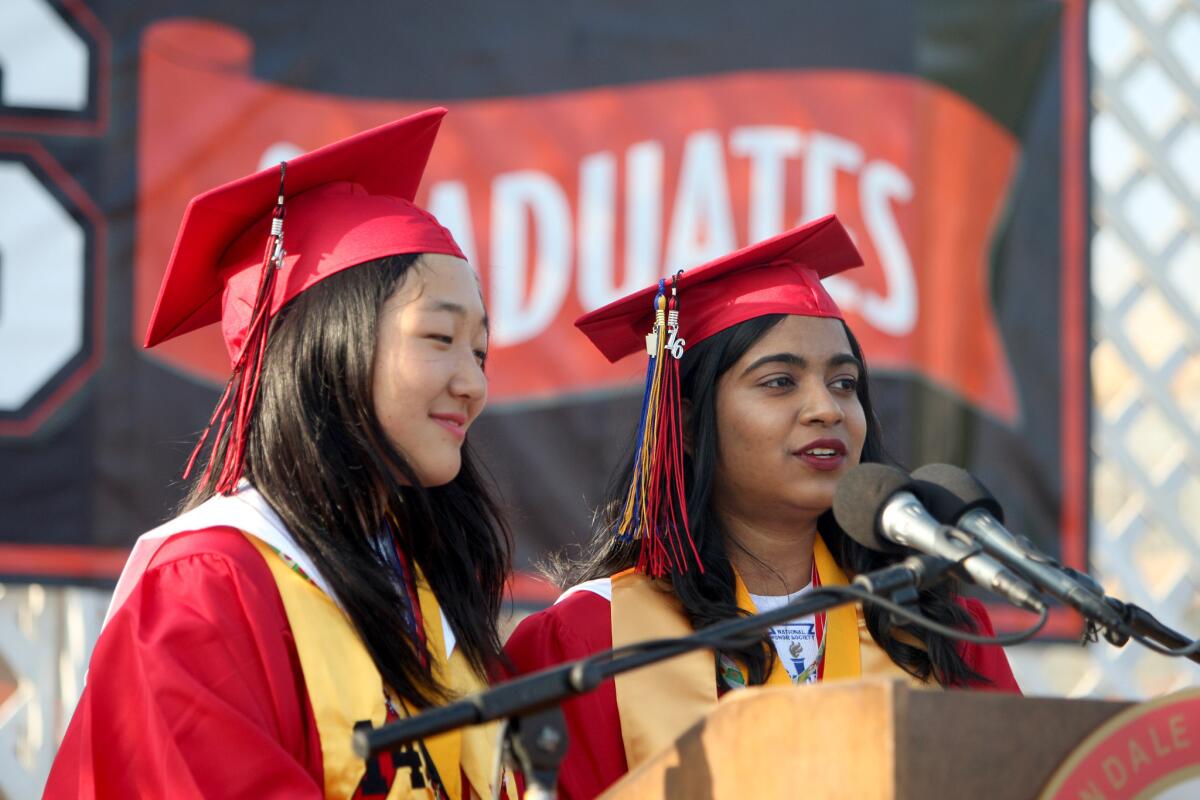 Valedictorian Jae Song, left, and Salutatorian Pooja Gupta, right, spoke together at Glendale High School's commencement ceremony on Wednesday, June 1, 2016.