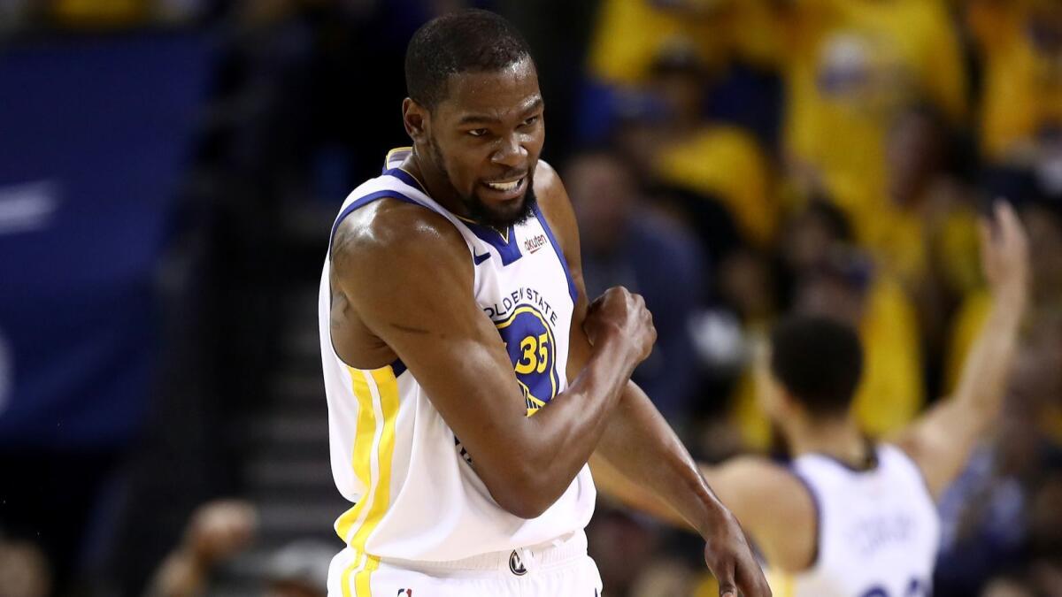 Warriors forward Kevin Durant reacts after scoring against the Rockets in Game 5 of their playoff series. He would later injure his right calf.