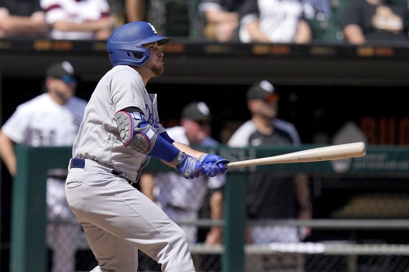 Los Angeles Dodgers' Max Muncy watches his two-run double off Chicago White Sox starting pitcher Dylan Cease during the fifth inning of a baseball game Thursday, June 9, 2022, in Chicago. (AP Photo/Charles Rex Arbogast)