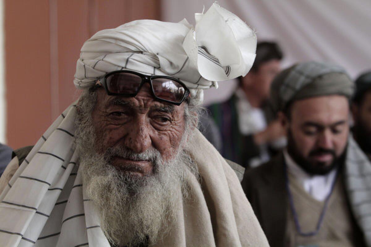 Afghan delegates listen to a speech on the second day of a loya jirga, or consultative council, in Kabul.