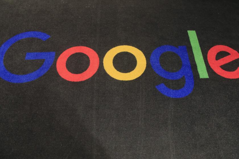 FILE - In this Monday, Nov. 18, 2019, file photo, the logo of Google is displayed on a carpet at the entrance hall of Google France in Paris. In a settlement announced Monday, Feb. 1, 2021, Google will pay $2.6 million to more than 5,500 employees and past job applicants to resolve allegations that the internet giant discriminated against female engineers and Asians in California and Washington state. (AP Photo/Michel Euler, File)