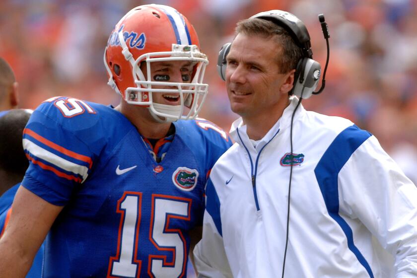 Florida quarterback Tim Tebow (15) shares a laugh with coach Urban Meyer during the fourth quarter of an NCAA college football game against Kentucky in Gainesville, Fla., Saturday, Oct., 25, 2008. Florida won 63-5. (AP Photo/Phil Sandlin)