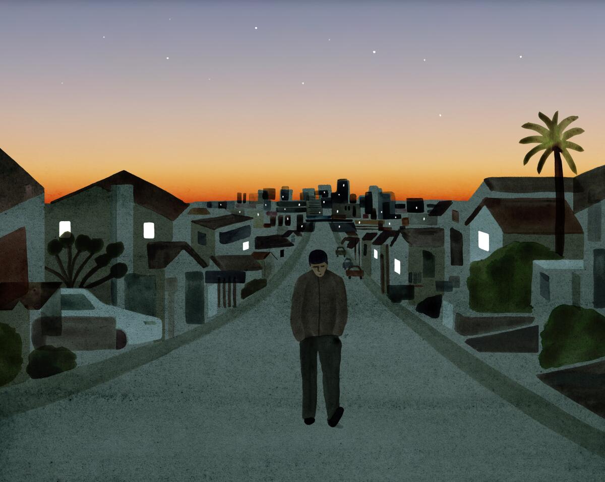 Head down, a man walks on an empty street. Behind him, Los Angeles glows in the light of sunset.