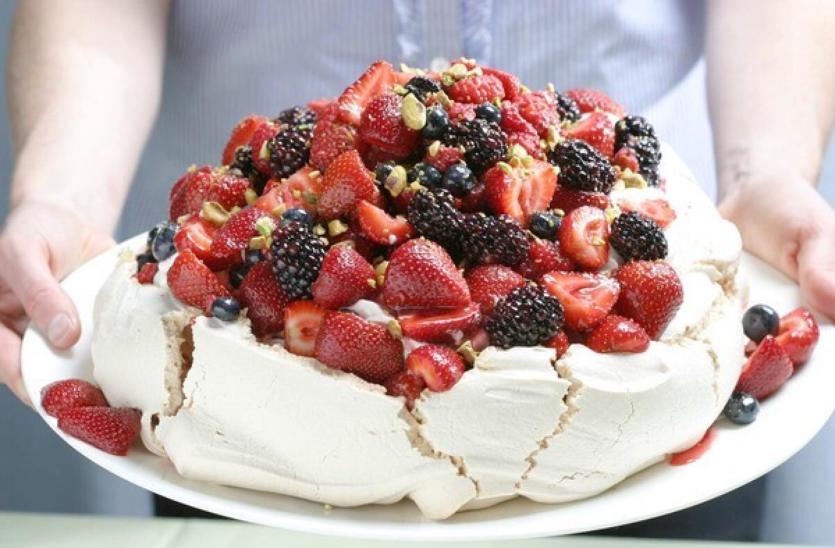 Dive on in. Recipe: Berry Pavlova with vanilla whipped cream and pistachios