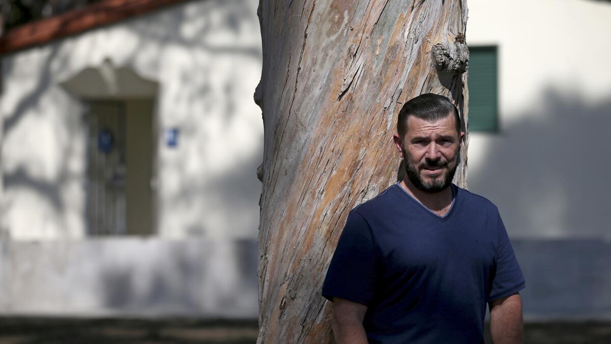 The handsome undercover cop smiles. Is he entrapping gay men or cleaning up  a park? - Los Angeles Times