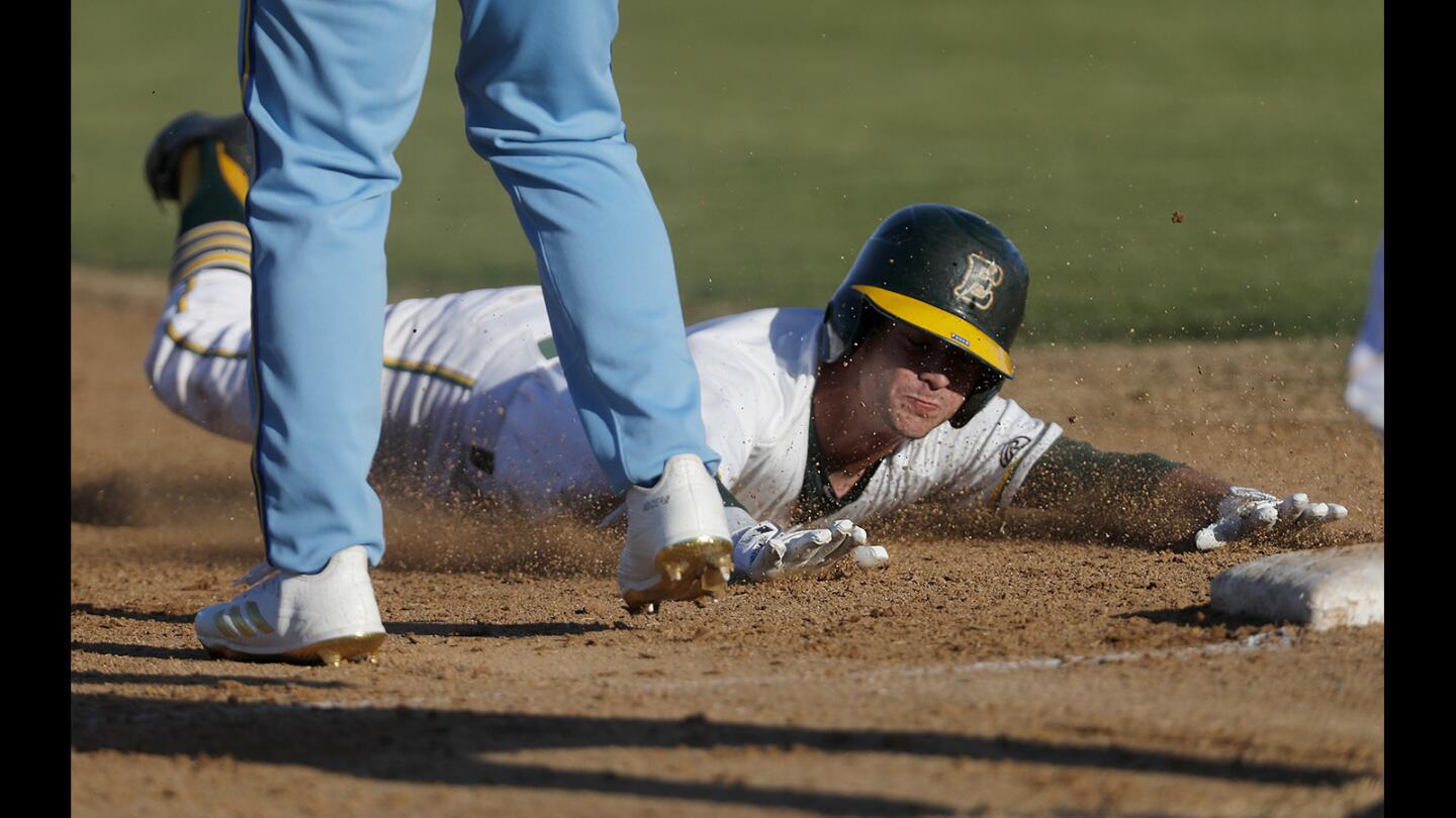 Edison High's Nolan Funke makes the slide to third base during the fifth inning against La Mirada in the Downey Tournament on Wednesday in Huntington Beach.