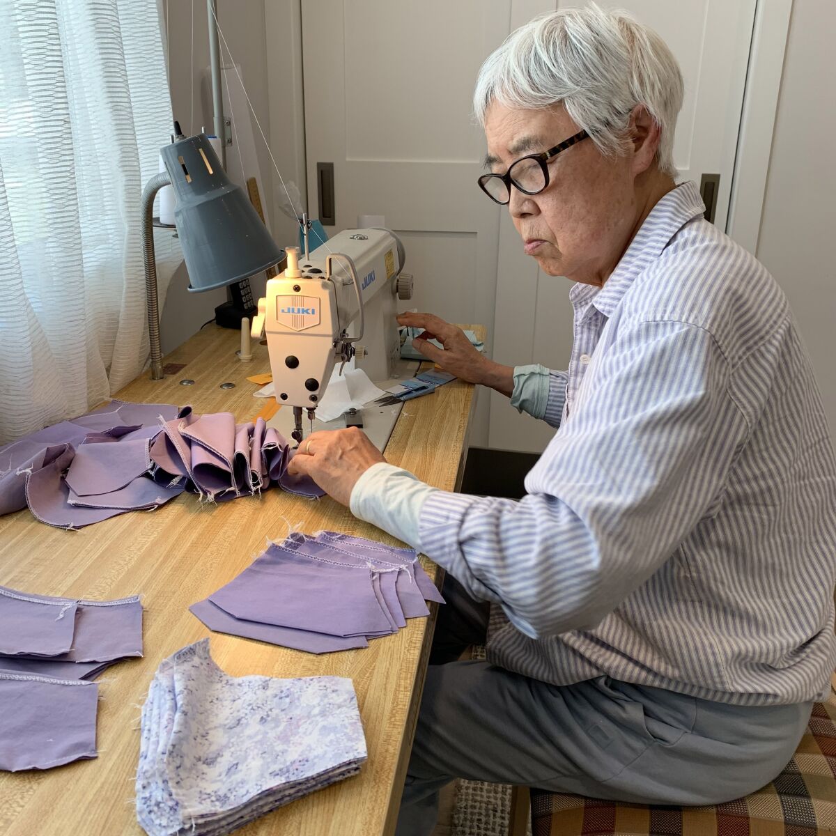Myong Won, 83, sews masks 