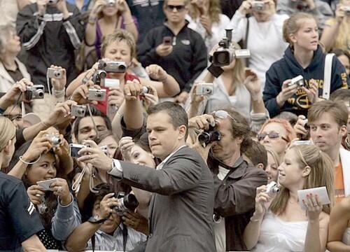 Matt Damon takes a picture of himself among a sea of fans at the Grauman's Chinese Theatre.