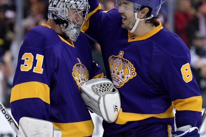 Kings goalie Martin Jones is congratulated by teammate Drew Doughty following the Kings' 3-0 victory Saturday over the New York Islanders.