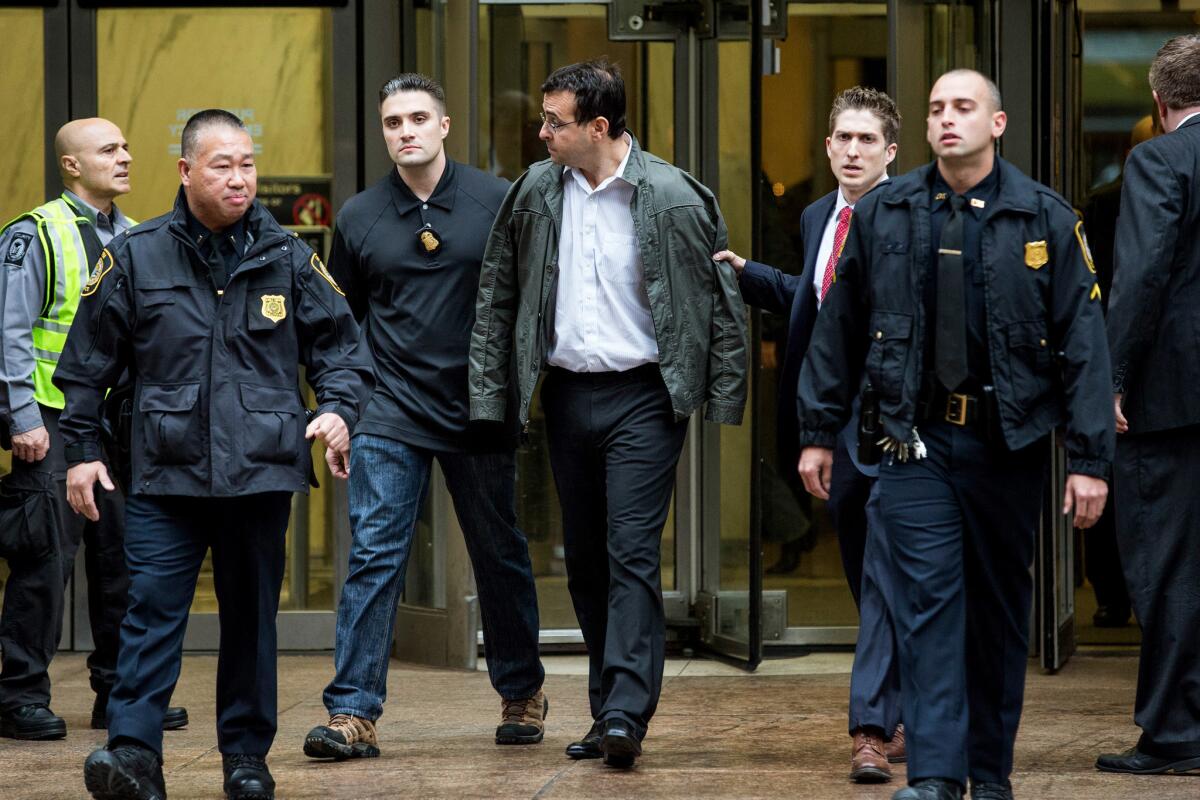 Attorney Evan Greebel, center, is brought out of 26 Federal Plaza by law enforcement officials after being arrested Dec. 17, 2015, in New York. He was sentenced Friday to 18 months behind bars for aiding "Pharma Bro" Martin Shkreli in an $11-million fraud.