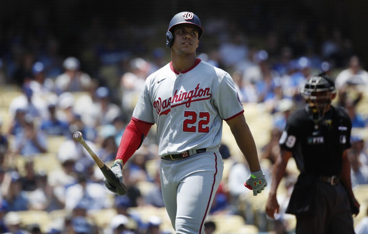 Washington Nationals right fielder Juan Soto walks back to the dugout after striking out against the Dodgers.