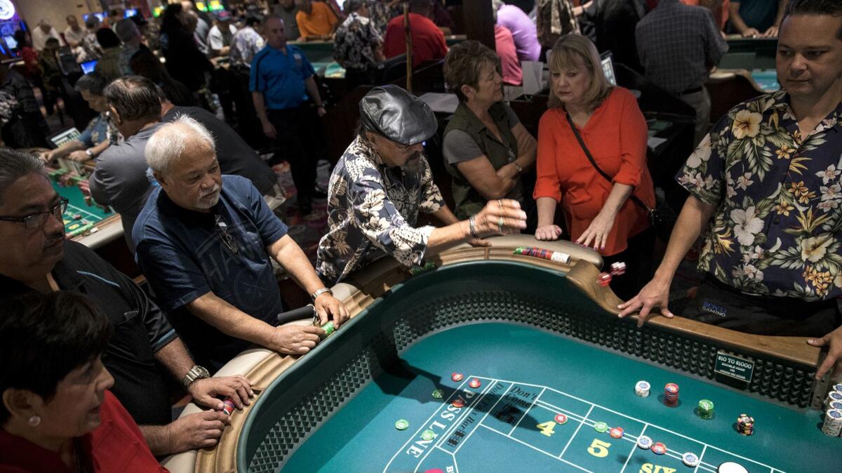 Richard Favela tosses the dice during a qualifying round at the California Hotel and Casino Golden Arm Craps Tournament.