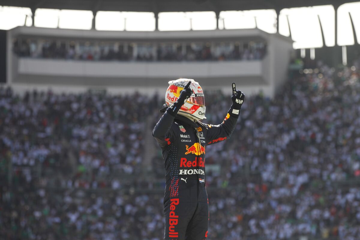 Red Bull driver Max Verstappen, of The Netherlands, celebrates his win in the Formula One Mexico Grand Prix auto race at the Hermanos Rodriguez racetrack in Mexico City, Sunday, Nov. 7, 2021. (Francisco Guasco, Pool Photo via AP)