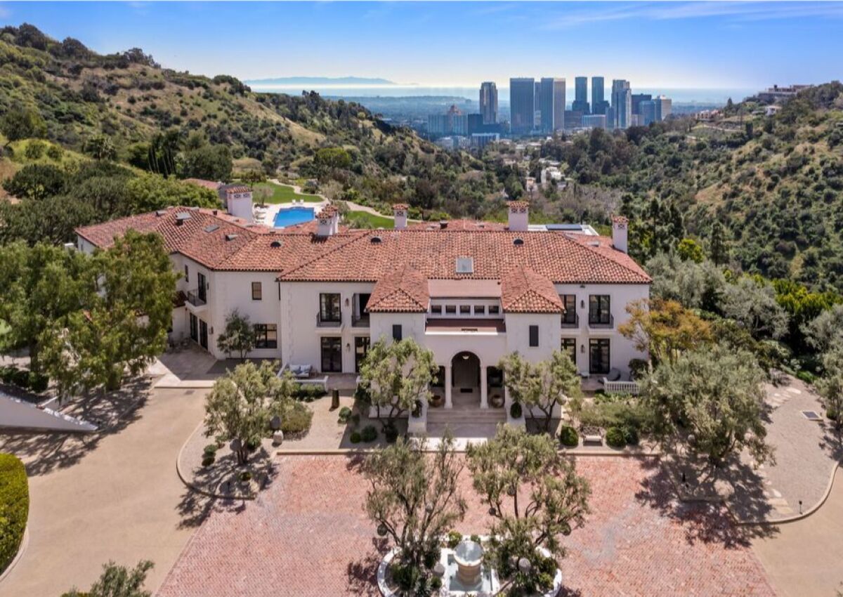 An aerial view of the Tuscan-style home, with downtown in the background