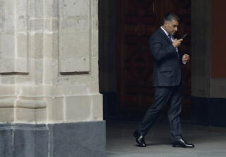 Omar García Harfuch talks on his cellphone