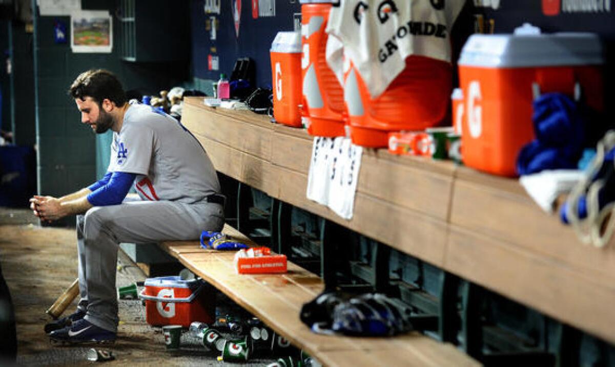 Pitcher Brandon Morrow sits alone in the dugout after giving up a lead in the seventh. (Wally Skalij / Los Angeles Times)