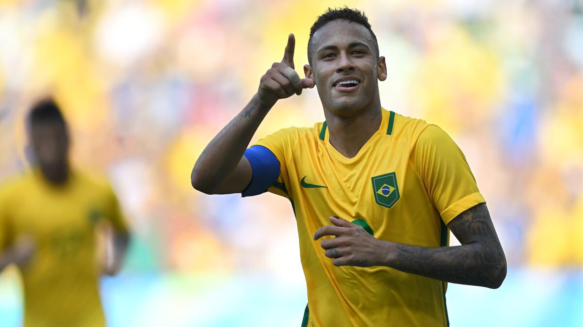 Brazilian striker Neymar celebrates after scoring on a penalty kick against Honduras.
