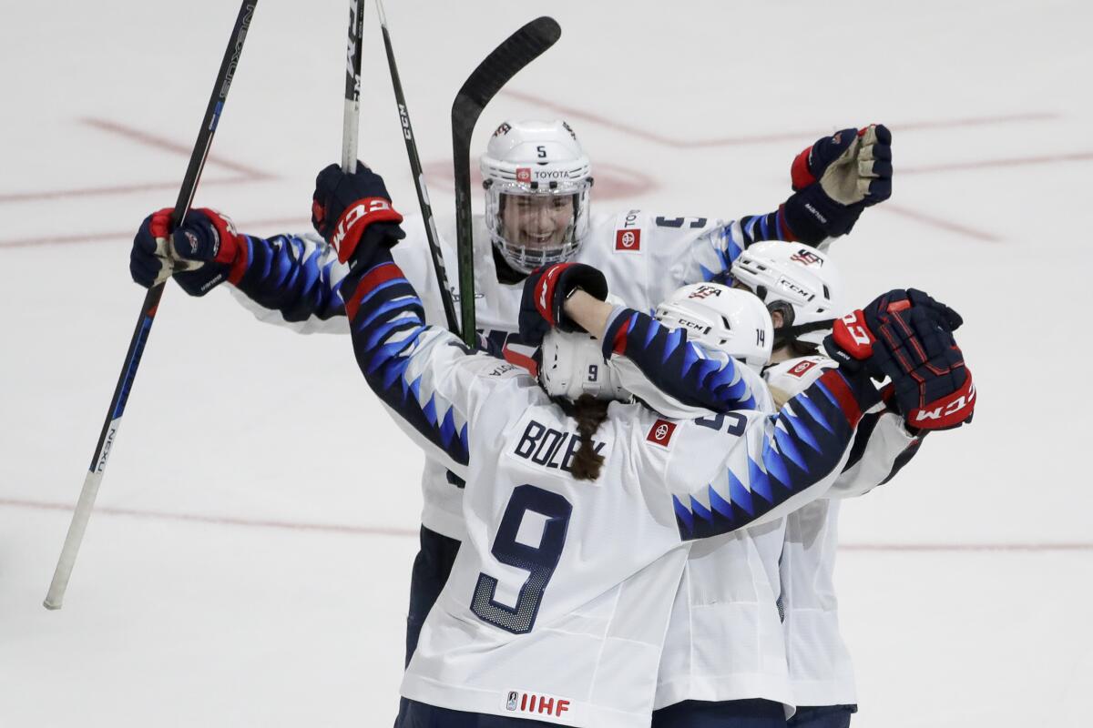 U.S. players celebrate the game-winning overtime goal by Megan Bozek (9) in their 4-3 win over Canada on Feb. 8, 2020, at Honda Center.