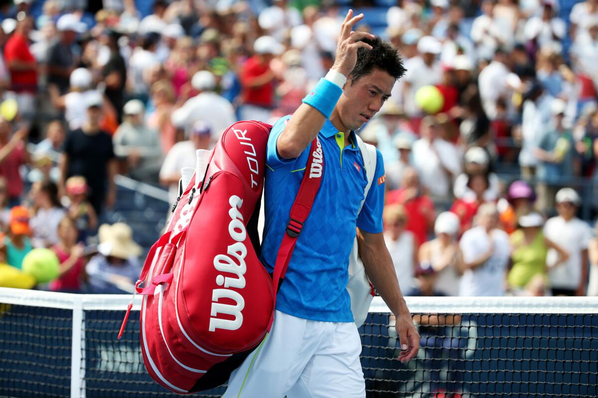 Kei Nishikori walks off of the court after losing against Benoit Paire during the first round of the 2015 U.S. Open.