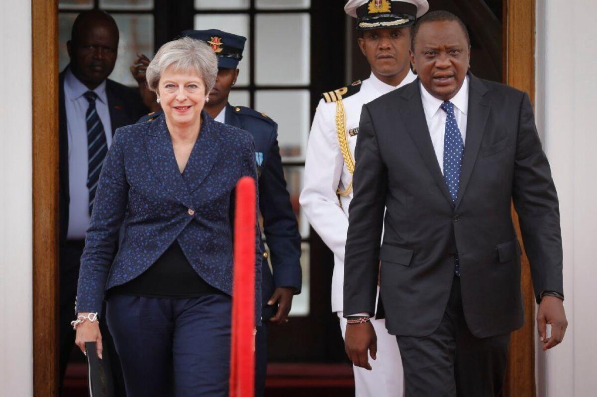 British Prime Minister Theresa May and Kenyan President Uhuru Kenyatta arrive for a news conference in Nairobi, Kenya, in August.