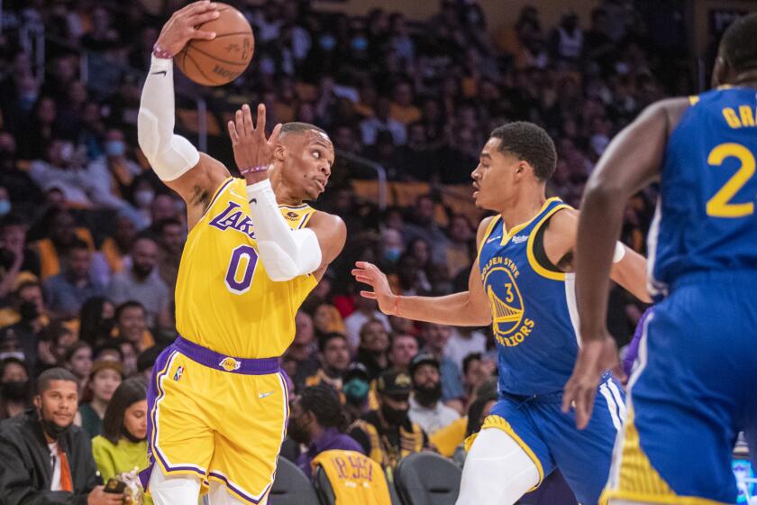 Lakers guard Russell Westbrook passes the ball over Golden State Warriors guard Jordan Poole