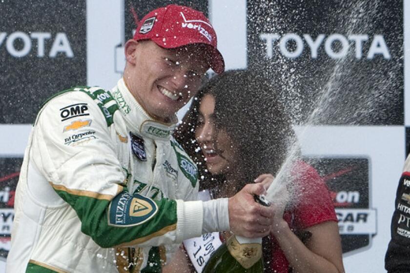 IndyCar Series driver Mike Conway celebrates on the podium after winning the Toyota Grand Prix of Long Beach on Sunday.
